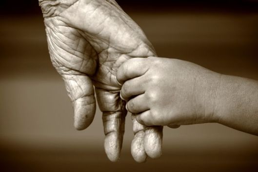 elderly-woman-and-child-holding-hands-750